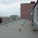 Rozmístění větracích komínků je klíčové pro správné odvětrávání střešního pláště bytového domu.